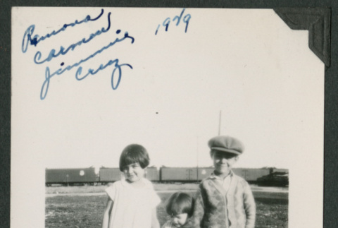 3 kids outside in front of a train (ddr-densho-378-722)