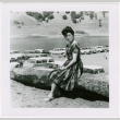 Tomoye (Nozawa) Takahashi sitting on log (ddr-densho-426-2200)