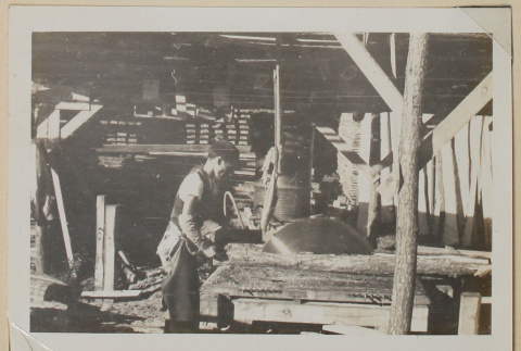 Man cutting wood (ddr-densho-433-670)