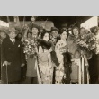A man and woman being greeted with bouquets (ddr-njpa-1-1882)