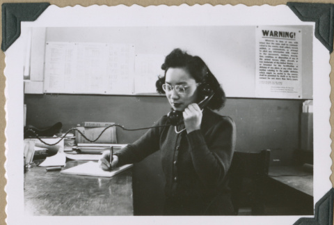 Woman answering phone (ddr-densho-397-58)
