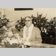 Gregg M. Sinclair seated with flowers (ddr-njpa-2-1160)