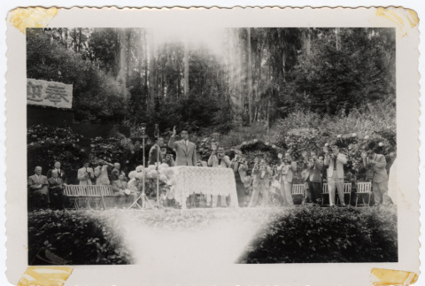 Man on a stage with photographers (ddr-densho-433-1222)