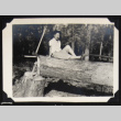 Nori poses with an ax and tree (ddr-densho-542-685)