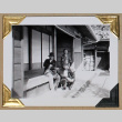 Two men and a woman on a porch (ddr-densho-404-295)