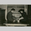 Two Japanese Americans playing cards (ddr-densho-159-231)