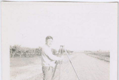 Man setting up tripod (ddr-densho-377-1646)