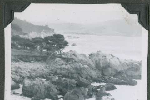 Soldier standing on a rocky outcrop (ddr-densho-201-744)