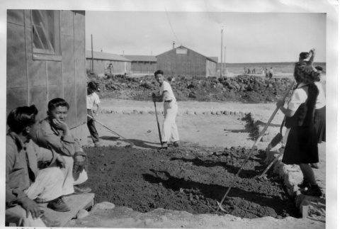 Japanese Americans working outside barracks (ddr-densho-37-721)