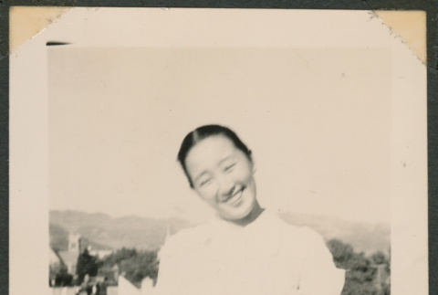 Woman smiling on a rooftop (ddr-densho-433-777)