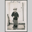 Photo of a child in front of a door (ddr-densho-483-712)
