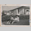Two women sitting on a lawn (ddr-manz-10-97)