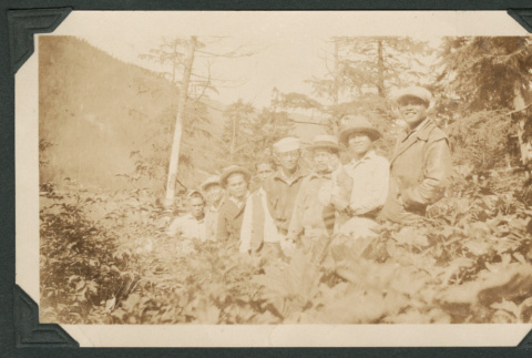 Photo of eight men in the woods (ddr-densho-483-224)