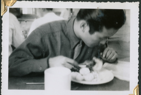 Man sitting at table eating (ddr-densho-434-265)
