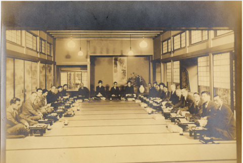 Photo of large group of men and women seated on tatami mats (ddr-densho-422-430)