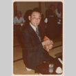 Man Smoking as He Unwraps Gift (ddr-ohs-1-265)