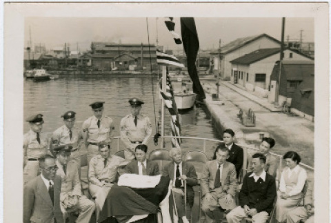 Civilians and soldiers pose on a boat (ddr-densho-359-1132)