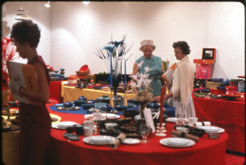 Two women by display of table settings (ddr-densho-426-374)
