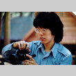 Mike Okagaki holding a camera (ddr-densho-336-1048)