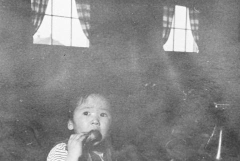 Child eating in mess hall (ddr-densho-39-18)
