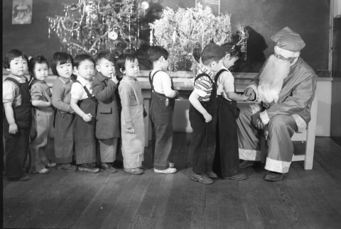 Children lined up to meet Santa (ddr-fom-1-411)