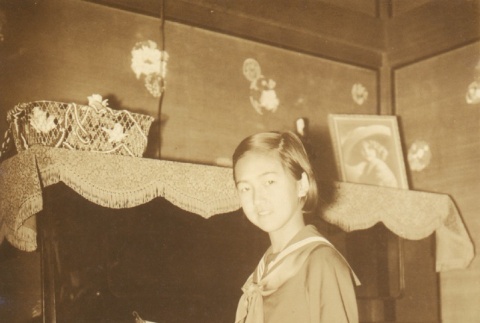 Girl posing at a piano (ddr-njpa-4-1330)