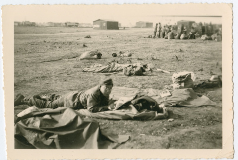 Soldier laying on sleeping mat outside (ddr-densho-368-133)
