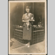 Woman standing outside shop (ddr-densho-523-48)