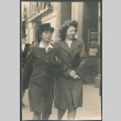 Two women walking on sidewalk (ddr-densho-523-180)