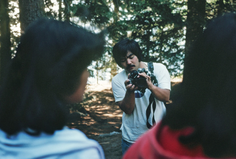 Robert Hanashiro taking photographs (ddr-densho-336-1231)