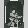 Man sitting on cot playing guitar (ddr-ajah-2-486)