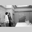Two behind podium (ddr-densho-1007-508)