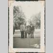 Two men and two children standing near a fountain (ddr-densho-321-166)