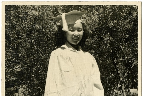 Woman wearing a graduation cap and gown (ddr-manz-6-25)
