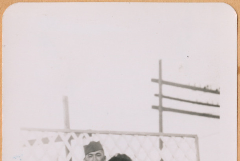 Joe and June (Kuramoto) Kumagai standing by lattice fence (ddr-densho-493-50)