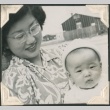 Woman with a baby in Heart Mountain concentration camp (ddr-densho-321-103)