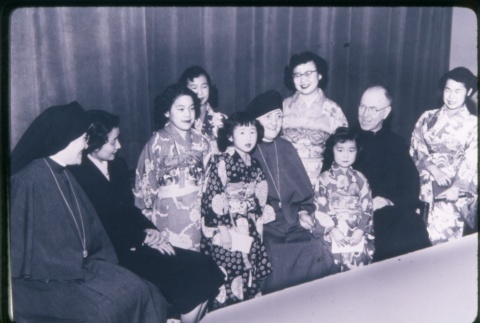 (Slide) - Image of girls in Kimono, nuns and priest seated (ddr-densho-330-32-mezzanine-2966029d70)