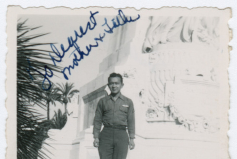 William Iino in front of statue in Nice, France (ddr-densho-368-275)