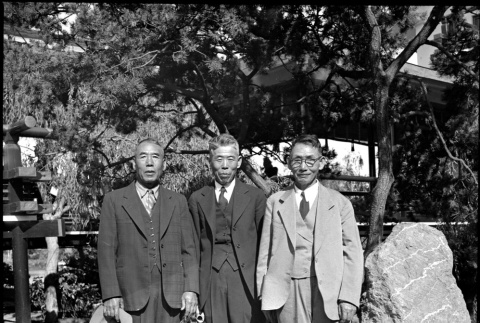 Three men standing in garden (ddr-densho-426-1629)