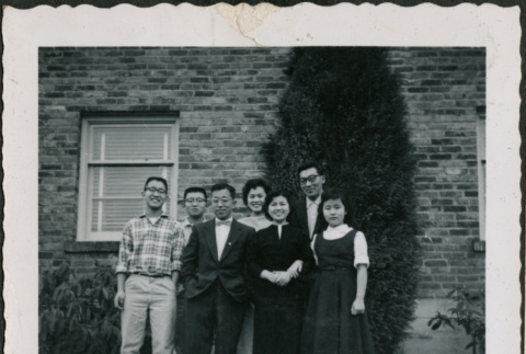 Seven people standing outside brick building (ddr-densho-293-115)