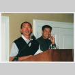 Tom Ikeda smiling behind Scott Oki at JACC Golf (ddr-densho-506-115)