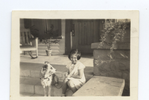 Girl sits on a porch with her dog (ddr-one-6-9)
