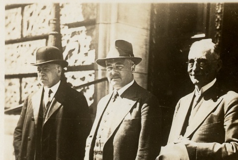 Three men standing outside a building (ddr-njpa-1-2359)