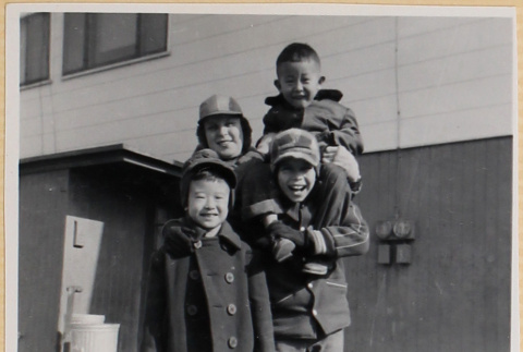 Four children outside building (ddr-densho-522-65)