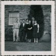 Seven people standing outside brick building (ddr-densho-293-115)