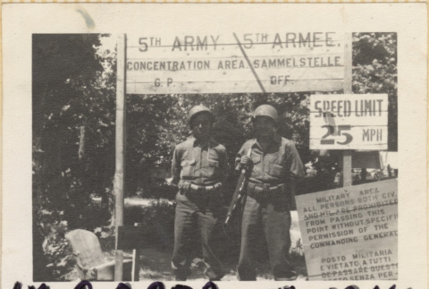 Two men standing under 5th Army sign (ddr-densho-466-365)