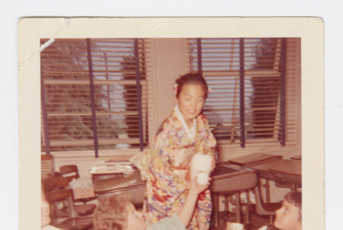 Elaine Komai pouring tea (ddr-densho-562-69)