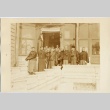A group of men standing outside a building (ddr-njpa-6-8)