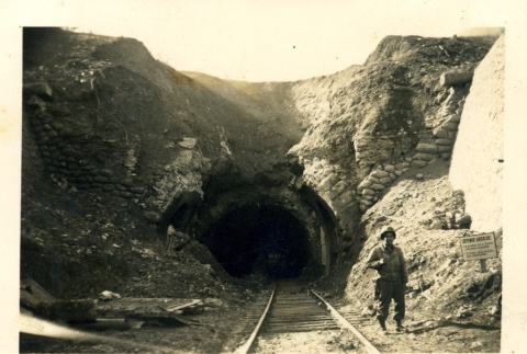 Danny Y. Teruda standing at the entrance of a railroad tunnel (ddr-densho-22-323)