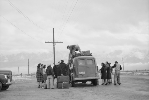 Japanese Americans loading a bus (ddr-densho-93-17)